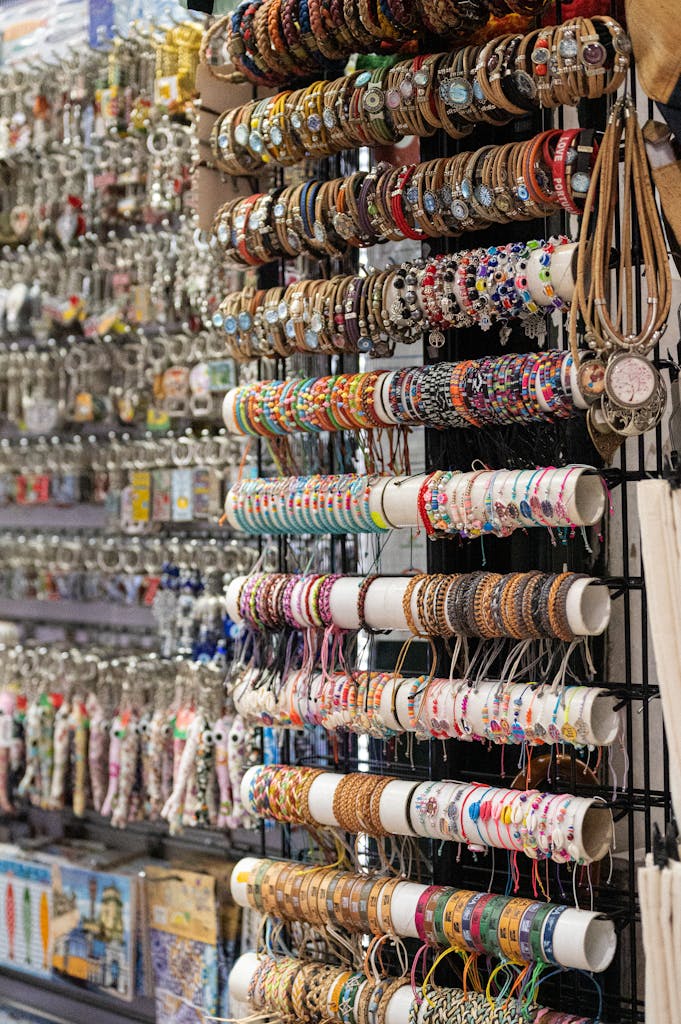 Vibrant assortment of bracelets and souvenirs hanging in a Lisbon shop.